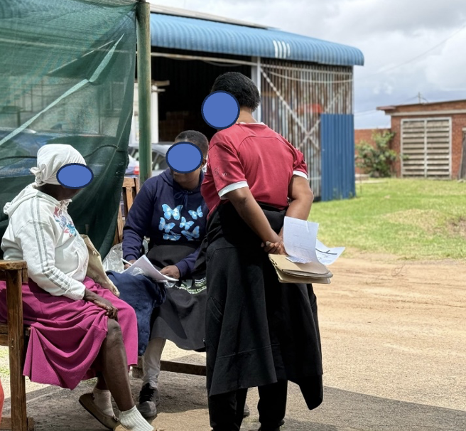 Community outreach workers meeting with women during a field consultation